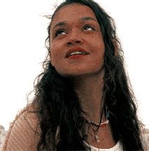 a woman with long hair looking up at the sky