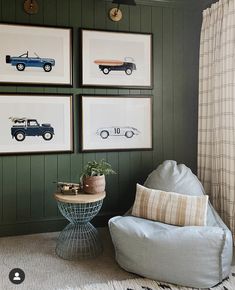 a living room with green walls and pictures on the wall