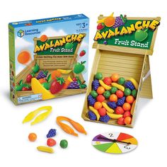 an assortment of fruit stand toys in front of a card game box with matching pieces