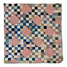 an old patchwork quilt is displayed on a white background with blue, pink and black squares