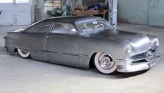 an old car is parked in a garage