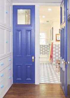 a bright blue door is open to the bathroom