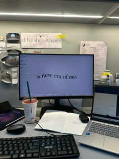 a desk with a laptop, keyboard and monitor on it