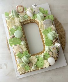 a decorated letter made out of cookies sitting on top of a table