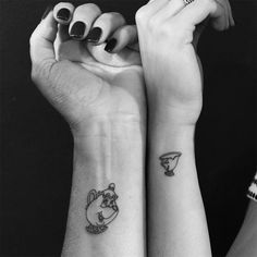 two people with matching tattoos on their arms