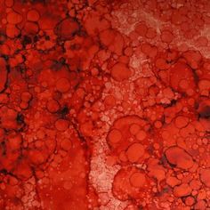 an orange and red painting with lots of bubbles on the bottom part of it,