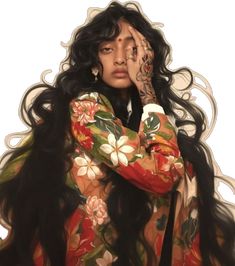 a woman with long black hair and tattoos on her face holding her hands to her face