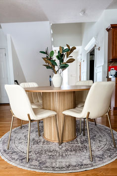 a round table with four chairs around it