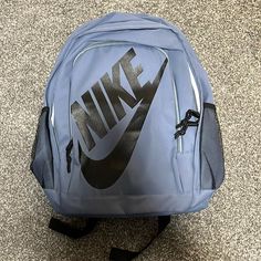 Blue Nike Backpack With Straps And Water Bottle Holder Cheap Nike Nylon Backpack, Cheap Nike Black Backpack, Cheap Nike Standard Backpack, Cheap Black Nike Backpack, Cheap Everyday Nike Backpack, Nike Tanjun Premium Backpack, Nike Standard Backpack, Gray Backpack For Streetwear, Blue Adjustable Strap Bag For Streetwear