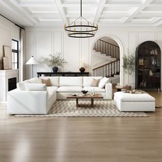 a living room filled with white furniture and a chandelier hanging from the ceiling