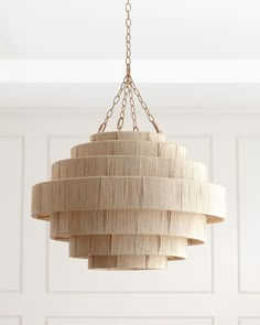 a wooden chandelier hanging from a ceiling in a room with white paneled walls