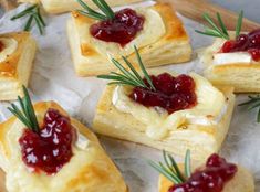 small pastries with cranberry sauce and rosemary sprigs