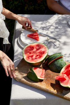 watermelon slices being cut on a cutting board