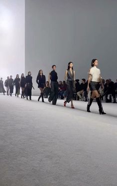 a group of people walking down a runway