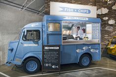 a blue food truck parked inside of a building