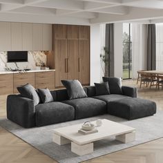 a living room filled with furniture next to a kitchen and dining room table on top of a hard wood floor