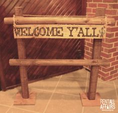 a wooden sign that says welcome y'all