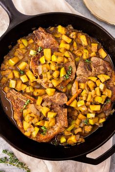 pork chops and potatoes in a cast iron skillet