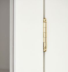 a white door with a gold handle on it