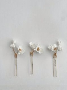 Inspired by Hampshire countryside and florals, make a statement with those gorgeous bridal hair pins. Comes as a set of 3 hairpins, crafted of ivory clay flowers and adorned with gold bead seeds. Clay flowers, Silver/Gold plated jewellery wire. This design can be customised (contact us for more info). As each of our pieces is handmade especially for you, we are unable to accept returns/exchanges (please contact us for more info). Hair Pins Bridal, Bridal Art, Bridal Hair Pin, Flower Hair Pins, Floral Hair Pins, Clay Flower, Wedding Hair Pins, Flower Hair Pin, Bridal Hair Pins