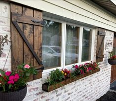 flowers are in the window boxes on the side of a building