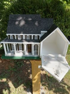 a model house with a hot tub in the yard next to it's roof