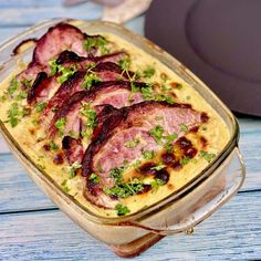 a casserole dish filled with meat and garnished with parsley on top