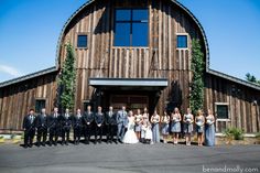 a large group of people standing in front of a barn