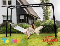 a woman sitting in a hammock with a child