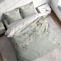 an image of a bed with flowers on the comforter and pillow cases in this room