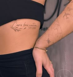 a close up of a person's stomach with tattoos on her left side and the words going forward written in cursive writing