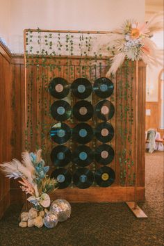 an arrangement of record records and flowers on display