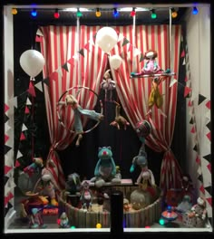 an image of a window display with clowns and circus animals on it's windowsill