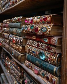 many books are stacked on top of each other in a book store, all covered with jeweled covers