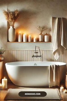 a white bath tub sitting in a bathroom next to candles