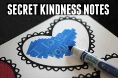 a blue marker sitting on top of a piece of paper with the words secret kindness notes written in it