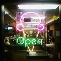 a neon sign that reads open with headphones on it