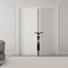 an open door in a white room with chairs