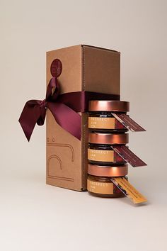 an open box with chocolates in it and a ribbon on the top that is tied around