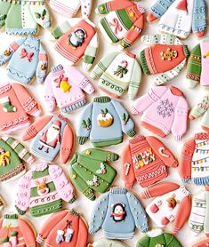 decorated cookies in the shape of sweaters and mittens