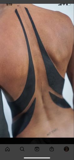 the back of a woman's body with black lines on her upper and lower back