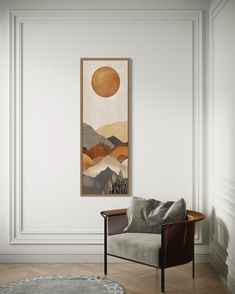 a living room with a chair, rug and painting hanging on the wall above it