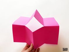 someone is holding an origami box in their hand and it looks like they are going to make something out of paper