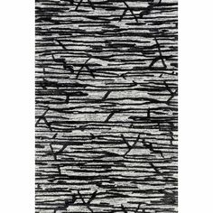 an area rug with black and white lines on the ground, in front of a white background