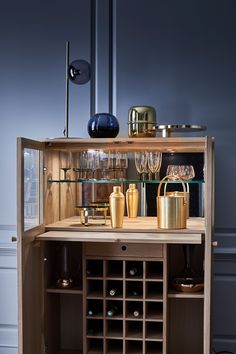 a wine cabinet with many bottles and glasses