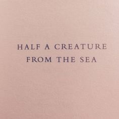 the words half a creature from the sea are written in blue ink on pink paper