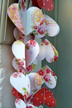 some paper hearts hanging from a door