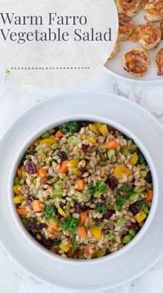 a white bowl filled with vegetable salad on top of a table next to other food