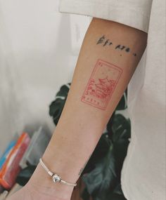 a woman's arm with a small tattoo on the left side of her arm