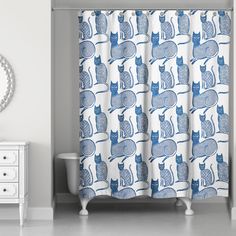 a blue and white shower curtain with cats on it